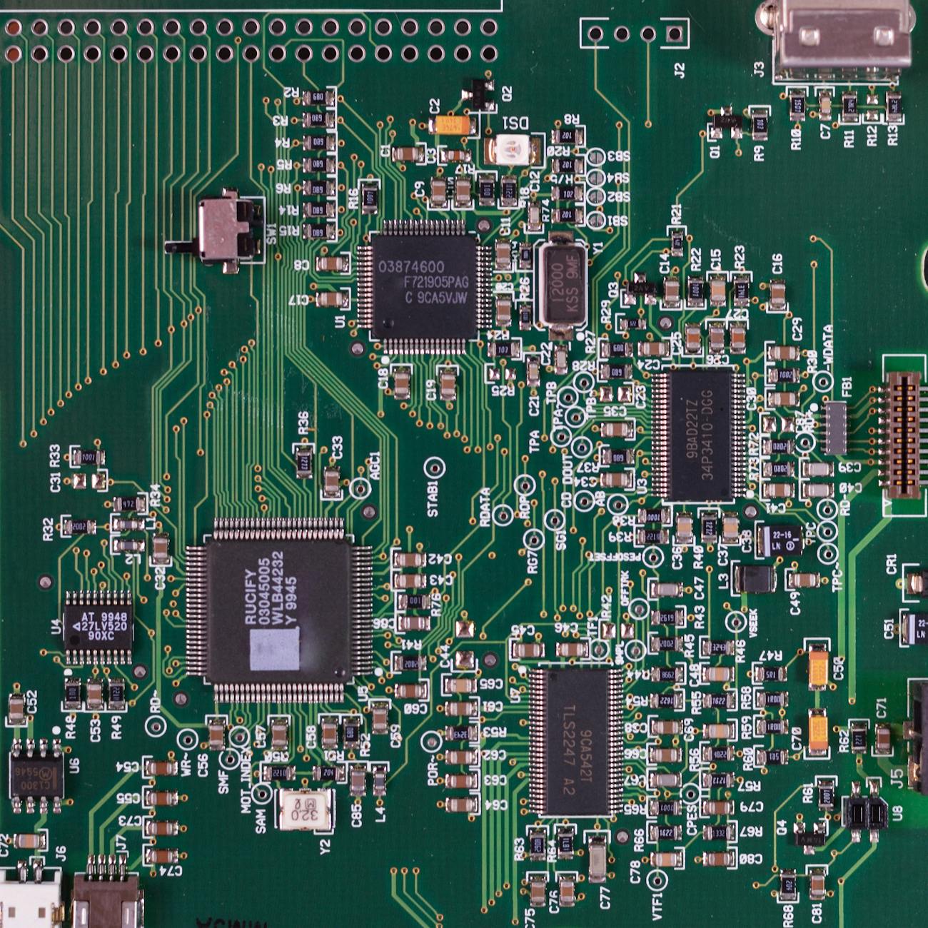 Detailed image of a green circuit board featuring various components and microprocessors.